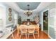 Dining room with hardwood floors, chandelier, Christmas tree, and natural light at 575 Crystal Spring Dr, Sanford, NC 27332