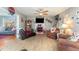 Spacious living room with cozy fireplace, ceiling fan, and view into adjacent room at 575 Crystal Spring Dr, Sanford, NC 27332