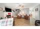 Bright living room with ceiling fan, fireplace, and view into entry of the home at 575 Crystal Spring Dr, Sanford, NC 27332