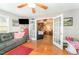 Comfortable living room with French doors, hardwood floors, a ceiling fan, and natural light at 575 Crystal Spring Dr, Sanford, NC 27332