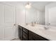 Double vanity bathroom with dark brown cabinets and white countertop at 5940 Illuminate Ave, Raleigh, NC 27616