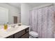 Bathroom with dark vanity and floral shower curtain at 5940 Illuminate Ave, Raleigh, NC 27616