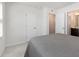 Bright bedroom with a gray comforter and an attached bathroom at 5940 Illuminate Ave, Raleigh, NC 27616