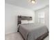 Bedroom with rustic wood headboard and gray bedding at 5940 Illuminate Ave, Raleigh, NC 27616