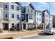 Row of three story townhouses with gray siding and gray roofs at 5940 Illuminate Ave, Raleigh, NC 27616