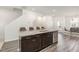 Modern kitchen island with granite countertops and dark brown cabinetry at 5940 Illuminate Ave, Raleigh, NC 27616