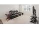 Living room with black leather reclining sofa and large TV at 5940 Illuminate Ave, Raleigh, NC 27616