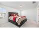 Spacious main bedroom with dark brown platform bed and gray bedding at 5940 Illuminate Ave, Raleigh, NC 27616