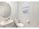 Small half bathroom with white pedestal sink and toilet at 5940 Illuminate Ave, Raleigh, NC 27616