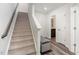 Carpeted staircase with a gray bench at the landing at 5940 Illuminate Ave, Raleigh, NC 27616