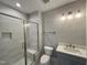 Bathroom with tiled walk-in shower, glass door, and stylish vanity sink at 90 Firefly Ln, Louisburg, NC 27549