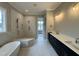 Luxurious bathroom with a soaking tub, walk-in shower, and double vanity, creating a spa-like retreat at 90 Firefly Ln, Louisburg, NC 27549