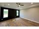 Well-lit bedroom with paneled accent wall and neutral tones, offering a serene and inviting space at 90 Firefly Ln, Louisburg, NC 27549