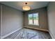 Well-lit bedroom featuring a contemporary light fixture and a large window at 90 Firefly Ln, Louisburg, NC 27549