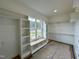 Walk-in closet with custom shelving and a window seat, maximizing storage and organization at 90 Firefly Ln, Louisburg, NC 27549
