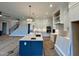 Open-concept kitchen featuring a large island, white cabinets, and stainless steel appliances, great for entertaining at 90 Firefly Ln, Louisburg, NC 27549