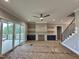 Inviting living room with a stone fireplace, custom built-ins, and large sliding doors leading to an outdoor space at 90 Firefly Ln, Louisburg, NC 27549