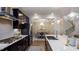 Open kitchen with stainless steel appliances, white countertops, and breakfast bar at 912 Thimbleweed Way, Wake Forest, NC 27587