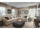 Spacious Gathering room featuring a sectional sofa, ottoman, and large windows at 1008 Country Pasture Cv, Wendell, NC 27591