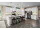 Open kitchen featuring white cabinets, granite counters, and an island with seating at 1008 Country Pasture Cv, Wendell, NC 27591