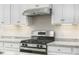Stainless steel range and granite countertops in this modern kitchen at 1008 Country Pasture Cv, Wendell, NC 27591