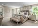 Large main bedroom with plush bedding and a neutral color palette at 1008 Country Pasture Cv, Wendell, NC 27591