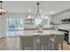 Bright kitchen boasts an island, stainless steel appliances, and white backsplash at 1018 Lake Dr, Siler City, NC 27344