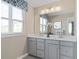 Elegant bathroom with double vanity, large mirror, and updated fixtures at 1020 Country Pasture Cv, Wendell, NC 27591
