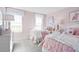 Charming bedroom with twin beds, light pink walls, and plenty of natural light at 1020 Country Pasture Cv, Wendell, NC 27591
