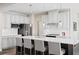 Modern kitchen with white cabinets, large island, and stainless steel appliances at 1020 Country Pasture Cv, Wendell, NC 27591
