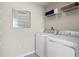 Convenient laundry room with washer, dryer, and shelving at 1020 Country Pasture Cv, Wendell, NC 27591