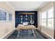 Home office with built-in shelving, hardwood floors, and large window at 1020 Country Pasture Cv, Wendell, NC 27591