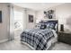 Blue and gray plaid bedding and nightstands in a bedroom at 1024 Country Pasture Cv, Wendell, NC 27591