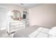 Bright bedroom featuring a mirrored vanity, soft lighting, and a peek into the spacious closet at 1024 Country Pasture Cv, Wendell, NC 27591
