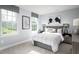 Cozy bedroom featuring two large windows, a plaid comforter and sports-themed art at 1024 Country Pasture Cv, Wendell, NC 27591