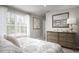 Comfortable bedroom with a dresser, mirror, and large window at 1024 Country Pasture Cv, Wendell, NC 27591