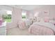 Charming pink bedroom with two twin beds, white furniture, and matching unicorn decor at 1024 Country Pasture Cv, Wendell, NC 27591