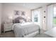 Charming bedroom with soft pink walls, a comfortable bed, and natural light streaming through the windows at 1024 Country Pasture Cv, Wendell, NC 27591