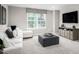 Cozy bonus room with a comfortable couch, ottoman, and a large window for natural light at 1024 Country Pasture Cv, Wendell, NC 27591