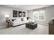 A relaxing bonus room featuring a comfortable sofa, a large window, and stylish decor at 1024 Country Pasture Cv, Wendell, NC 27591