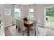 Dining area features a wood table, four chairs, and a view to the outdoor deck at 1024 Country Pasture Cv, Wendell, NC 27591