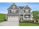 Charming two-story home featuring a well-manicured lawn, covered porch and a two-car garage with an ample driveway at 1024 Country Pasture Cv, Wendell, NC 27591