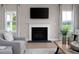 Close-up of a fireplace with a white mantel and a large flatscreen TV above at 1024 Country Pasture Cv, Wendell, NC 27591