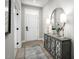 Inviting foyer featuring a decorative mirror, lamps, console table and area rug at 1024 Country Pasture Cv, Wendell, NC 27591
