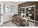 Functional home office setup with rustic desk, open shelving, and decorative accents at 1024 Country Pasture Cv, Wendell, NC 27591
