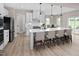 Kitchen features a large island, stainless appliances, light wood floors and a view to the back deck at 1024 Country Pasture Cv, Wendell, NC 27591