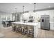 Bright kitchen with white cabinets, stainless steel appliances, and large island with seating for four at 1024 Country Pasture Cv, Wendell, NC 27591