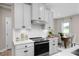 Kitchen with white cabinets, stainless oven, and tile backsplash open to the dining area at 1024 Country Pasture Cv, Wendell, NC 27591