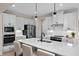 Kitchen features stainless appliances, white cabinets, a large island and light wood floors at 1024 Country Pasture Cv, Wendell, NC 27591