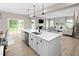 Open concept kitchen with island and view to the living area and sliding glass doors to the deck at 1024 Country Pasture Cv, Wendell, NC 27591